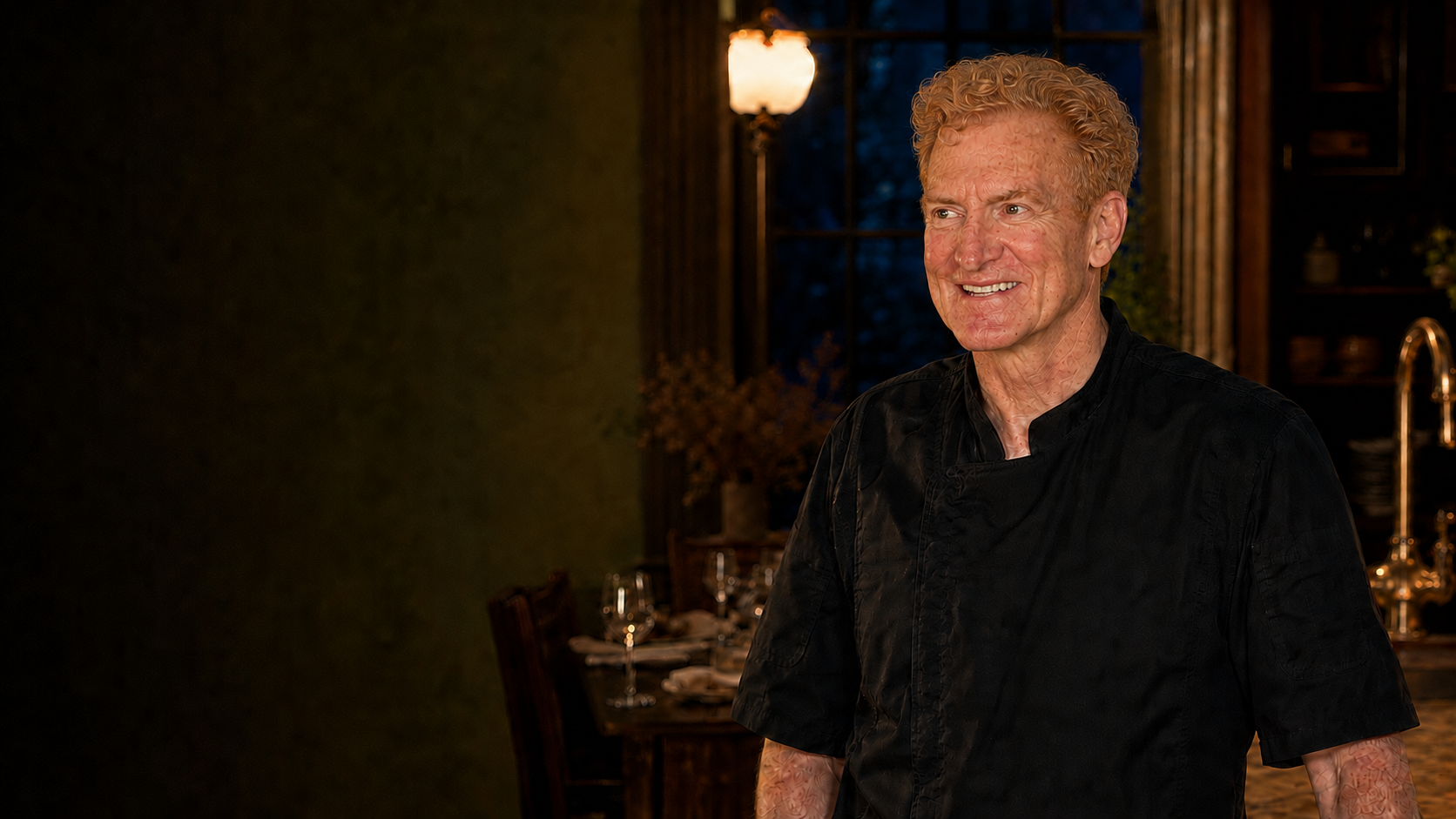 Chef David O’Brien in a warmly lit dining room